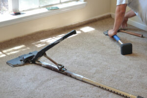 working installing new carpet and tools before clean up